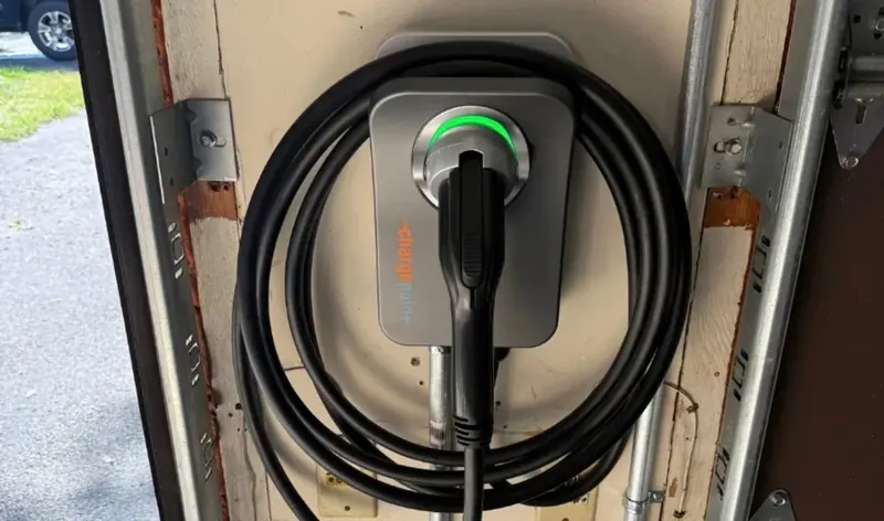 Level 2 EV charger installed on a garage wall